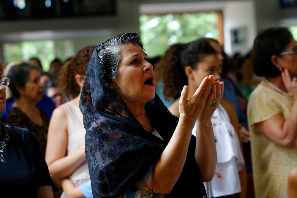 A woman prays during Mass at Divine Mercy Catholic Church in Managua, Nicaragua. A woman prays during Mass at Divine Mercy Catholic Church in Managua, Nicaragua.